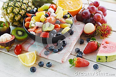 Fruit salad bowl fresh summer fruits and vegetables healthy organic food watermelon strawberries orange kiwi blueberries dragon Stock Photo