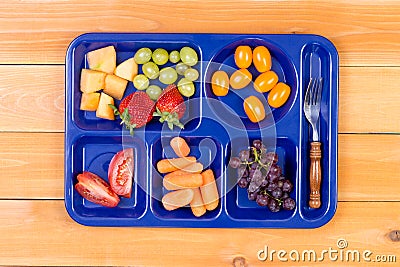 Fruit sampler in lunch tray with fork Stock Photo