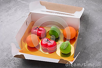 fruit-shaped mousse cakes in a box Stock Photo