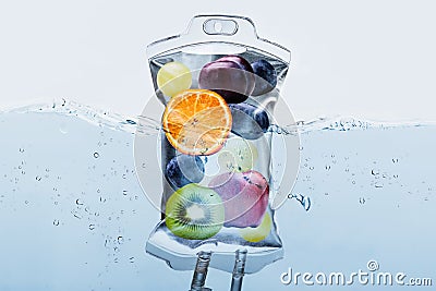 Fruit Slices In Saline Bag Dipped In Water Against Background Stock Photo
