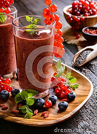 Fruit smoothies with red currants, blueberry, banana, goji berries and chia seeds Stock Photo