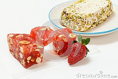 Fruit sweets with nuts and halva on white background. Stock Photo