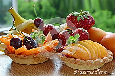 Fruit tart, mini baskets filled with fresh fruits Stock Photo