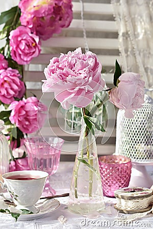 Fruit tea in beautiful porcelain cup and peony flowers Stock Photo