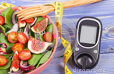 Fruit and vegetable salad, glucose meter for measurement sugar level and tape measure, concept of diabetes Stock Photo