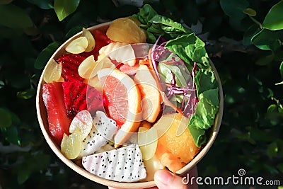 fruit and vegetable salad or orange, dragon fruit and lettuce salad Stock Photo