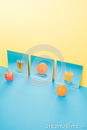 Fruits on blue table over yellow background Stock Photo