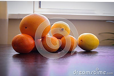 Fruits composition. Orange and lemon on table. Yellow orange brown whhite collors use in photo. Stock Photo