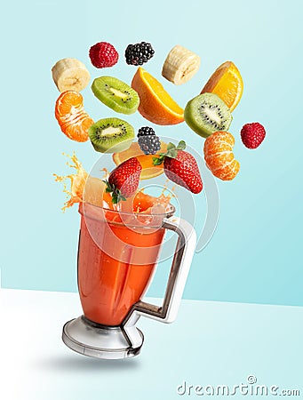 Fruits flying in a blender with fruit juice, isolated from the blue background Stock Photo