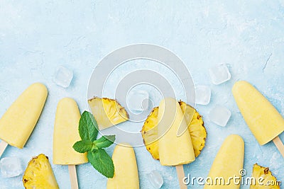 Fruity homemade ice cream or popsicles from pineapple top view. Summer refreshing food. Stock Photo