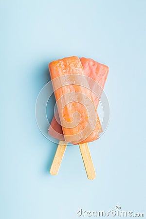 Fruity ice lolly. Sweet popsicle on blue table Stock Photo