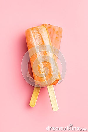 Fruity ice lolly. Sweet popsicle on pink table Stock Photo
