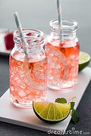 Fruity summer drinks with ice cubes in modern bottles Stock Photo