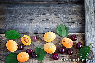 Fruity summer garden background with apricots and cherries. Top Stock Photo