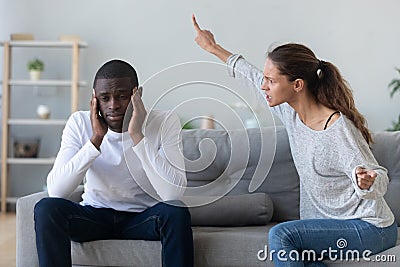 Frustrated african american man tired from quarreling shouting wife. Stock Photo