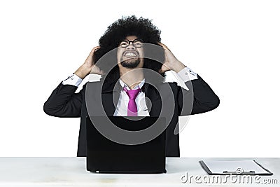 Frustrated Afro businessman with laptop Stock Photo