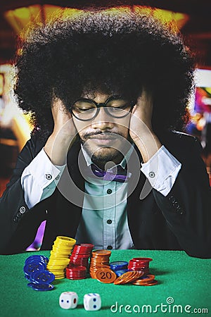 Frustrated Afro man in casino Stock Photo