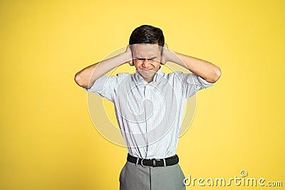 frustrated asian young businessman cover his ear Stock Photo