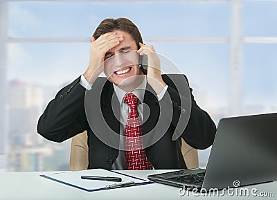 Frustrated business man talking on phone Stock Photo
