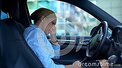 Frustrated businesswoman sitting in car, upset with failure on work, dismissal Stock Photo