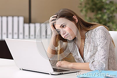 Frustrated intern working on line at office Stock Photo