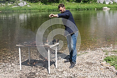 Frustrated male office worker hate his job. bearded guy, hipster in jacket set fire to desk, destroyed his workplace Stock Photo