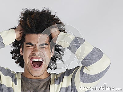 Frustrated Man With Afro Hairdo Pulling Hair Stock Photo