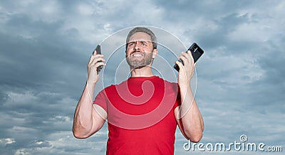 frustrated man has phone talk wear red tshirt. photo of man has phone talk. Stock Photo