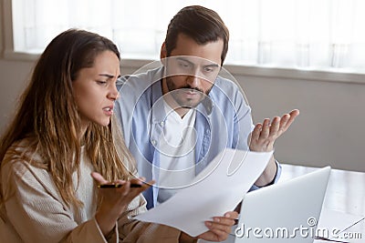 Frustrated married couple confused by paperwork from bank Stock Photo