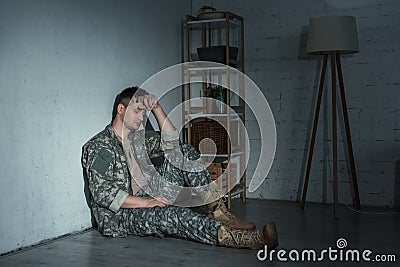 Frustrated military man with ptsd sitting Stock Photo