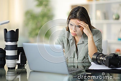 Frustrated photographer checking bad online news Stock Photo