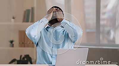 Frustrated shocked african businessman american adult man student work on computer make error mistake feels stress upset Stock Photo