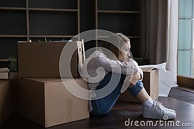 Frustrated tired former homeowner woman moving out from apartment Stock Photo