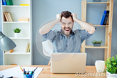 Frustrated tired man with laptop having a lot of work and screaming Stock Photo