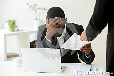 Frustrated upset african american employee receiving dismissal n Stock Photo