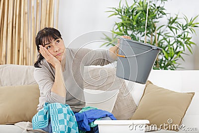 Frustrated woman during leaking roof or pipe burst Stock Photo