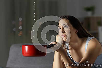 Frustrated woman looking at home water leaks Stock Photo