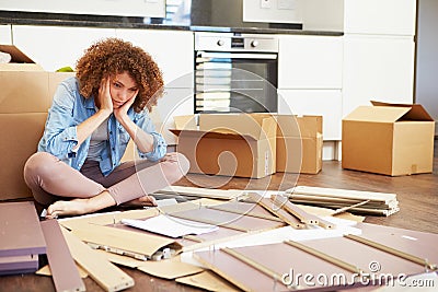 Frustrated Woman Putting Together Self Assembly Furniture Stock Photo