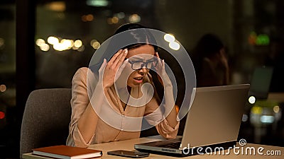 Frustrated woman working laptop, nervous about mistakes, stressful job, problem Stock Photo