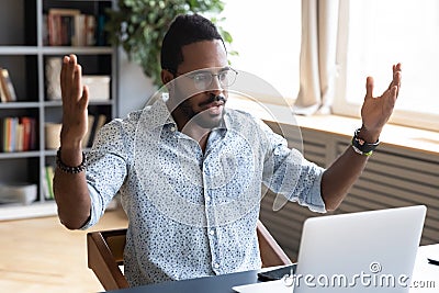 Frustrated young biracial man feeling shocked about online news. Stock Photo