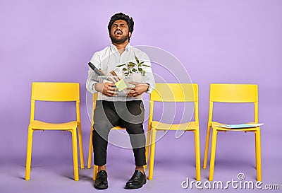 Frustrated young dark-skinned man quit job Stock Photo