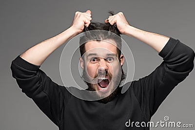 Frustration, man tearing hair out in anger Stock Photo
