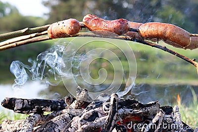 Fry sausages on fire Stock Photo