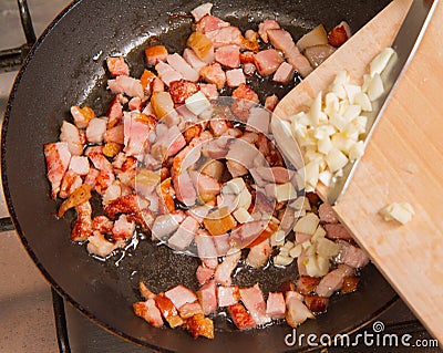Frying bacon with garlic Stock Photo