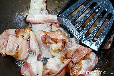 Frying bacon in the pan Stock Photo