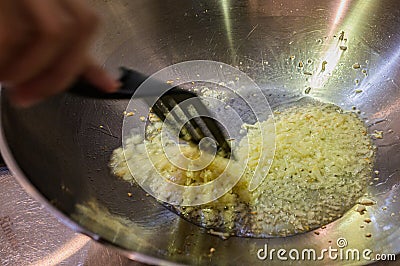 Frying chopped garlic in a wok. Stock Photo