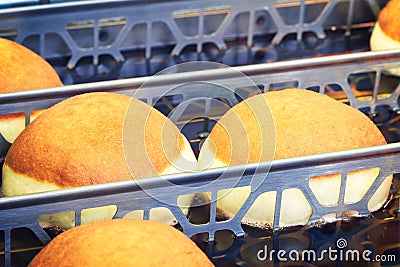 Frying donuts in oiled pans Stock Photo