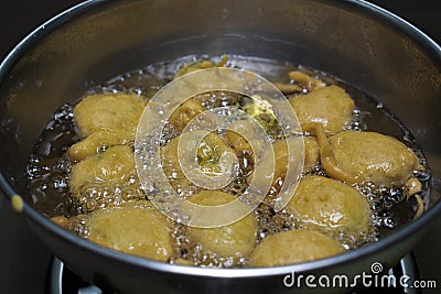 FRYING PAKORA ALOO BHAJIYA IN OIL Stock Photo