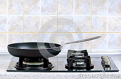 Frying pan on the gas stove Stock Photo