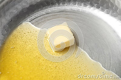 Frying pan with piece of melting butter Stock Photo